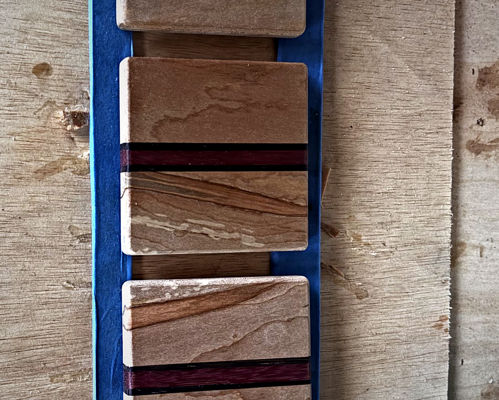 Maple and purpleheart blanks taped up on the workbench