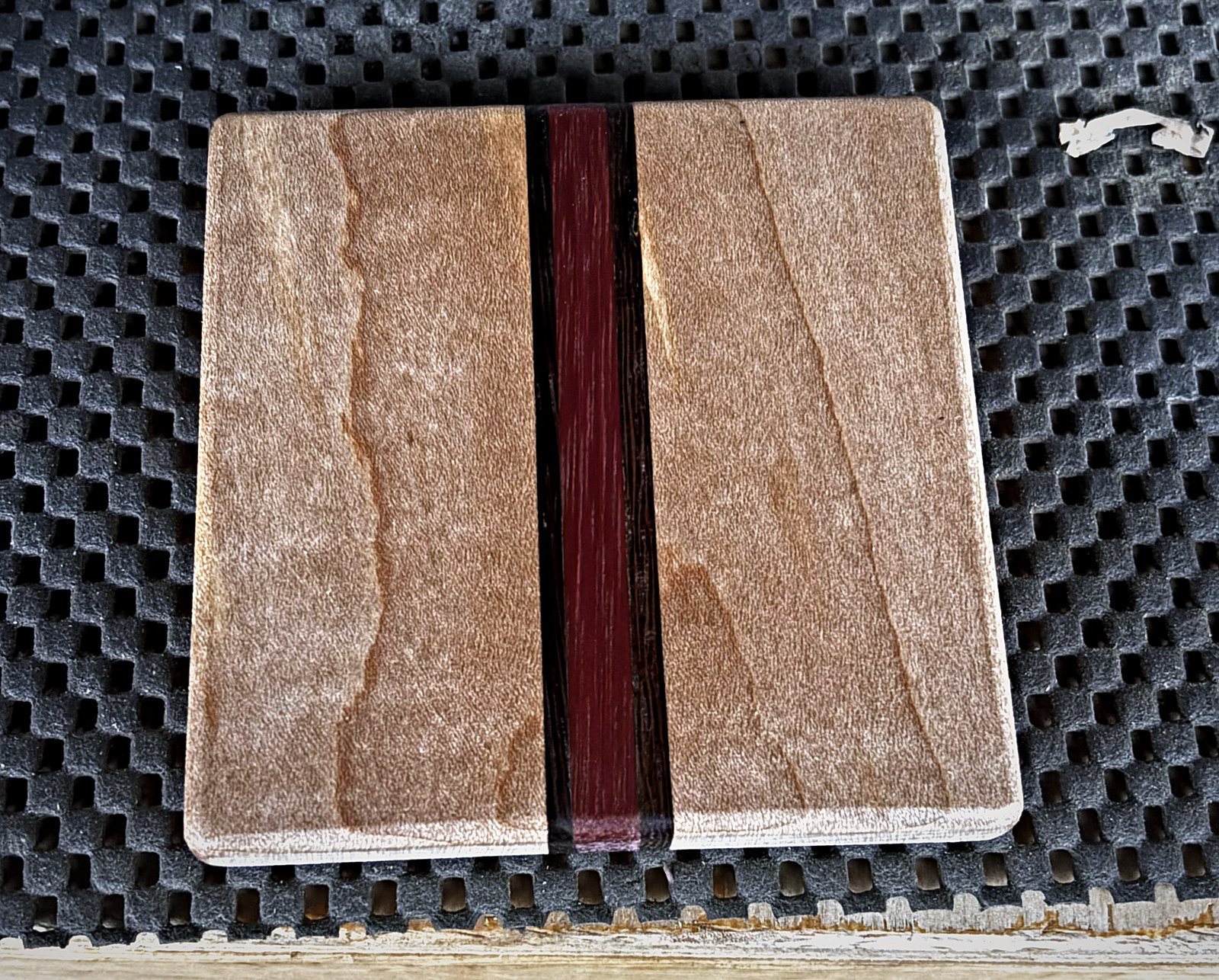 A maple and purpleheart coaster milled and squared, before any finish is applied