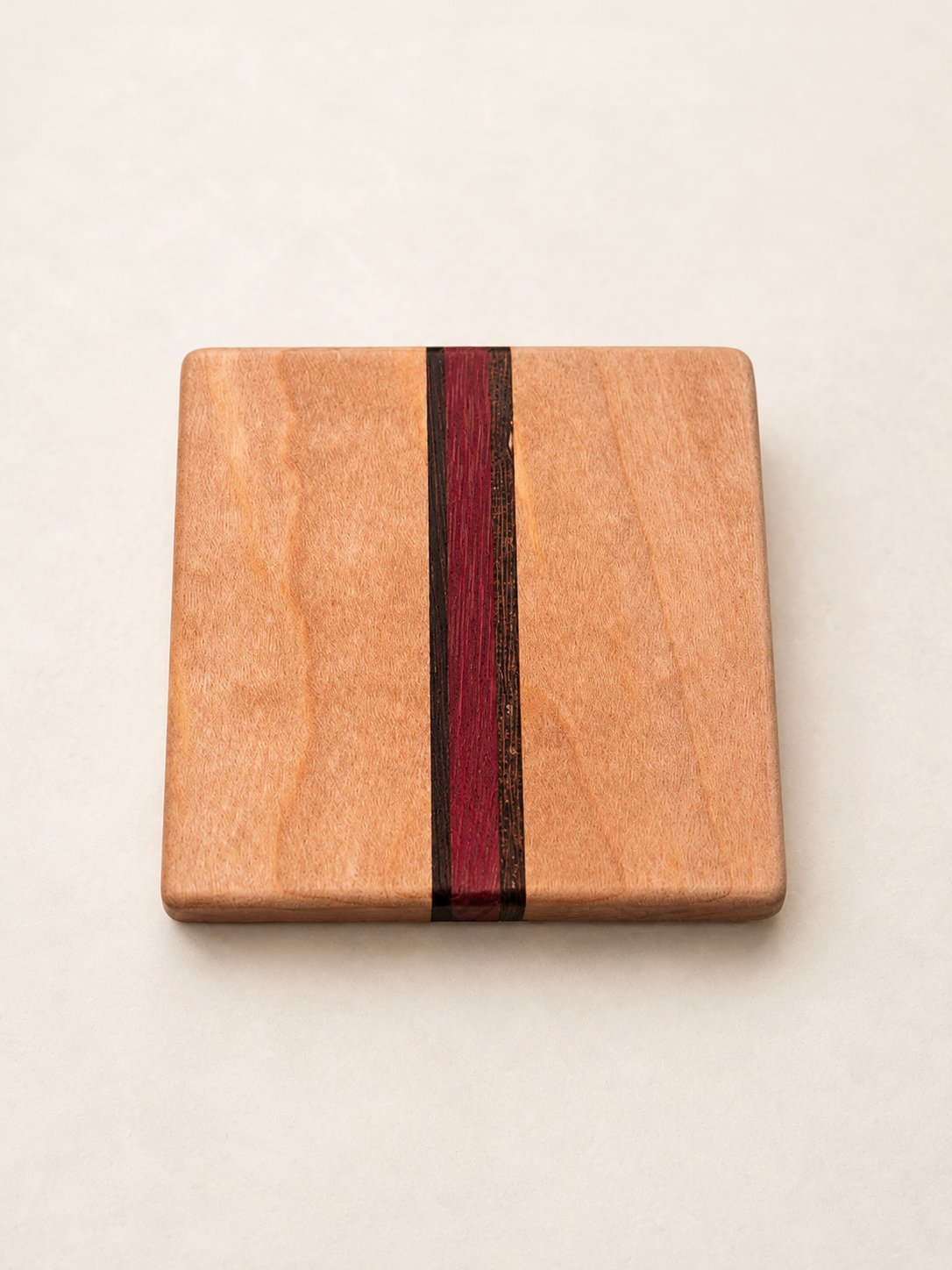 Maple coaster with a purpleheart accent strip