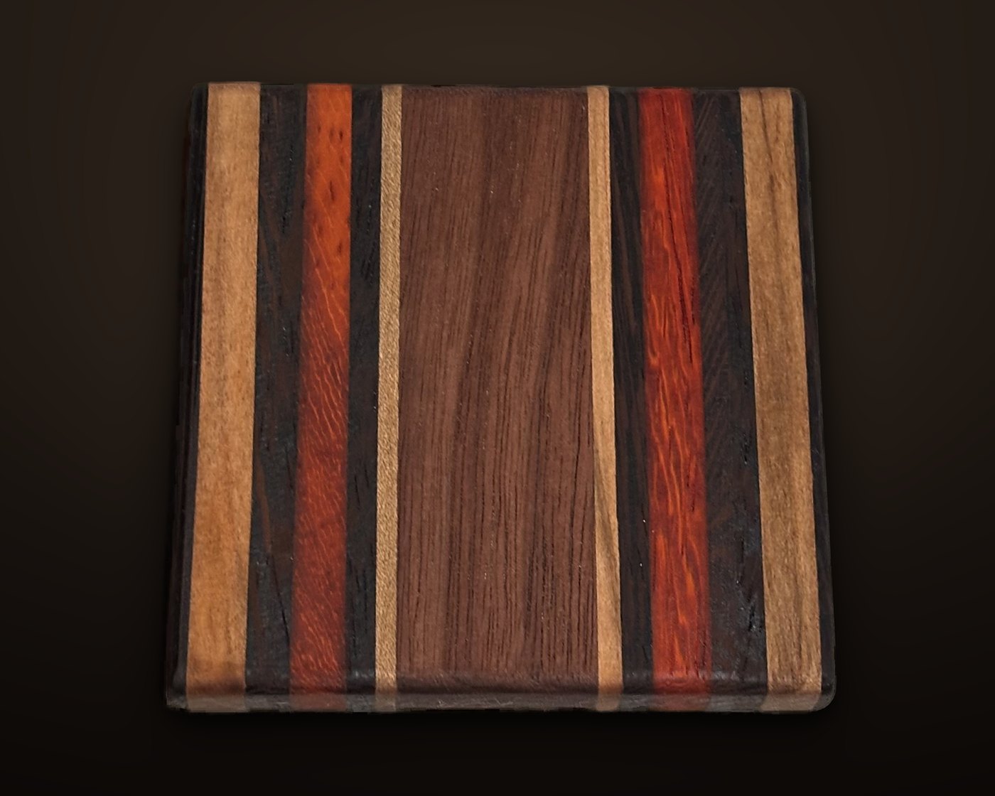 Exotic hardwood coaster laminated from padauk, wenge, maple and walnut