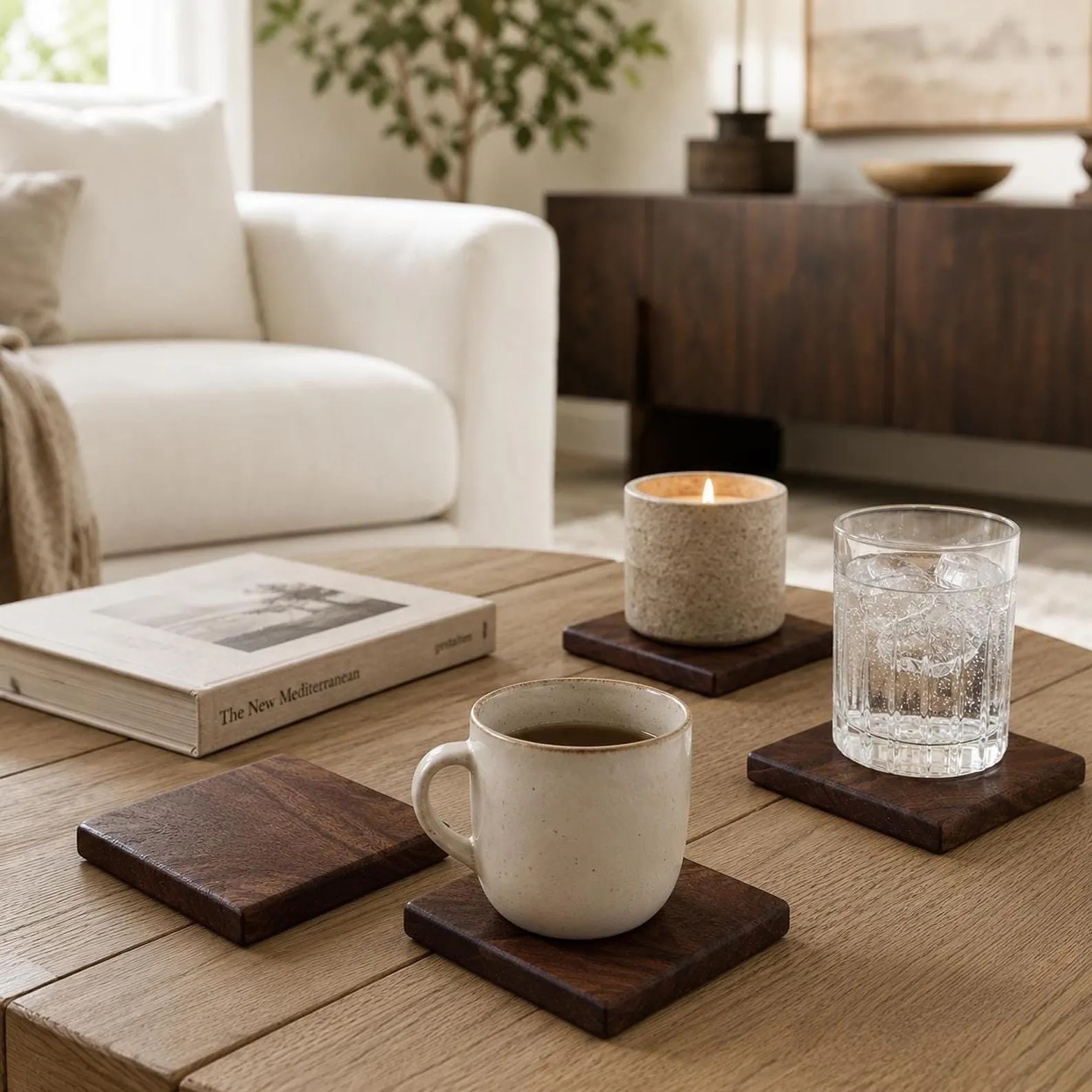 Walnut coasters on a coffee table with a mug and glass